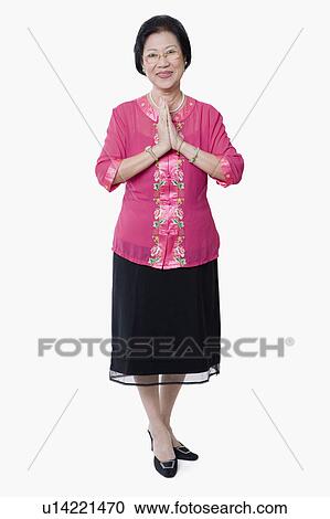 Portrait of a senior woman standing with her arms folded View Large Photo Image Stock Image - Portrait of a senior woman standing with her arms folded. Fotosearch