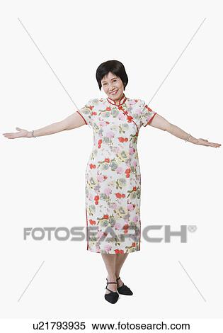 Stock Photography - Portrait of a senior woman standing with her arms outstretched. Fotosearch