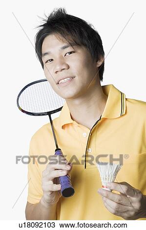 Portrait of a young man holding a badminton racket and a shuttlecock View Large Photo Image Stock Image - Portrait of a young man holding a badminton racket and a shuttlecock. Fotosearch