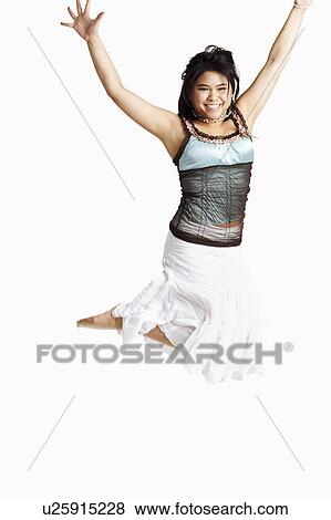 Portrait of a young woman jumping and smiling View Large Photo Image Stock Photo - Portrait of a young woman jumping and smiling. Fotosearch
