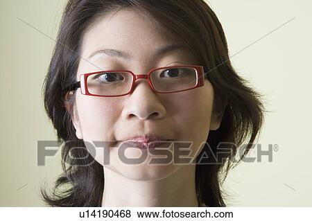 Portrait of a young woman looking serious View Large Photo Image Stock Photo - Portrait of a young woman looking serious. Fotosearch
