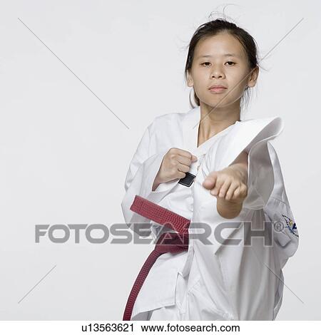 Portrait of a young woman performing front kick View Large Photo Image Stock Image - Portrait of a young woman performing front kick. Fotosearch