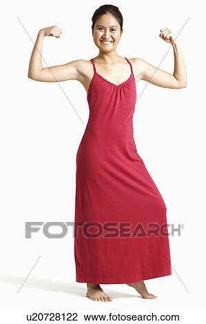 Portrait of a young woman showing her muscles View Large Photo Image Stock Image - Portrait of a young woman showing her muscles. Fotosearch