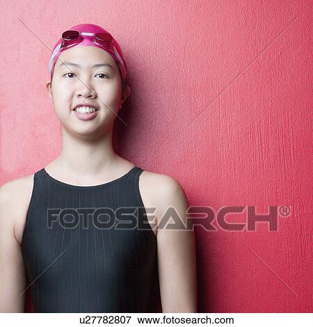 Stock Photo - Portrait of a young woman wearing swimwear and smiling. Fotosearch