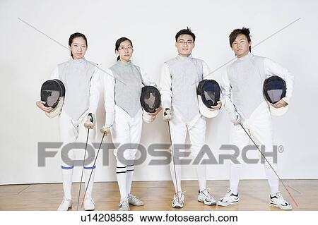 Portrait of two male and two female fencers holding fencing masks with fencing foils View Large Photo Image Stock Photography - Portrait of two male and two female fencers holding fencing masks with fencing foils. Fotosearch