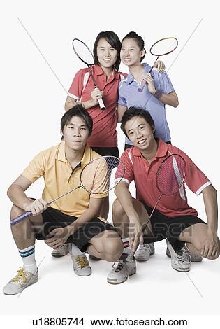 Portrait of two young couples holding badminton rackets and smiling View Large Photo Image Picture - Portrait of two young couples holding badminton rackets and smiling. Fotosearch