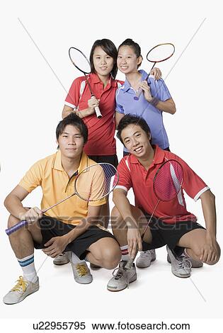 Portrait of two young couples holding badminton rackets and smiling View Large Photo Image Stock Photography - Portrait of two young couples holding badminton rackets and smiling. Fotosearch