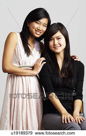 Portrait of two young women smiling View Large Photo Image Stock Photo - Portrait of two young women smiling. Fotosearch