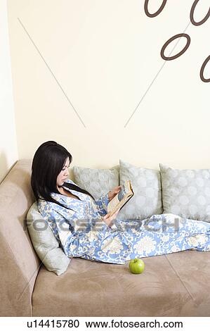 Side profile of a young woman reading a book View Large Photo Image Stock Image - Side profile of a young woman reading a book. Fotosearch