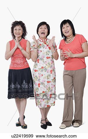 Stock Photo - Two senior women and a mature woman laughing. Fotosearch