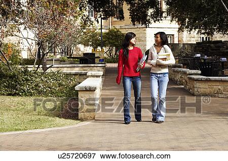 Stock Photo - Two young women walking in a college campus. Fotosearch