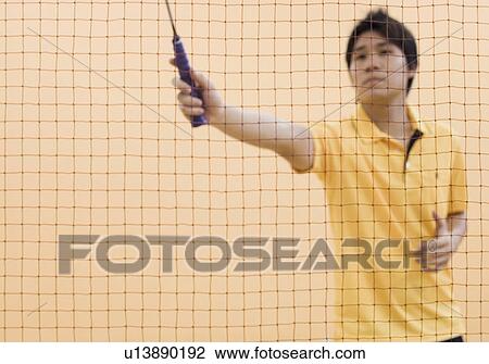 Young man playing badminton View Large Photo Image Stock Image - Young man playing badminton. Fotosearch