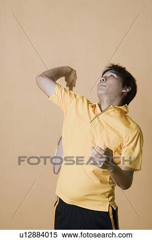 Young man playing badminton View Large Photo Image Stock Photography - Young man playing badminton. Fotosearch