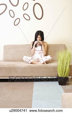 Young woman holding a cup View Large Photo Image Stock Image - Young woman holding a cup. Fotosearch