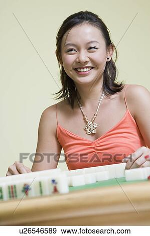 Young woman playing with blocks and smiling View Large Photo Image Stock Photo - Young woman playing with blocks and smiling. Fotosearch