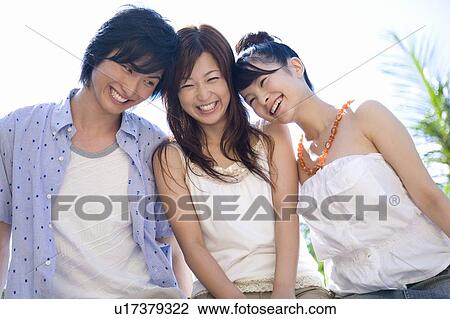 Stock Image - Friends smiling, Saipan. Fotosearch