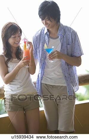 Young couple drinking cocktail, Saipan View Large Photo Image Picture - Young couple drinking cocktail, Saipan. Fotosearch