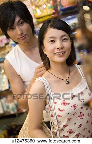 Stock Image - Young couple shopping, Siapan. Fotosearch