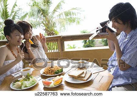 Stock Image - Young man with a camera, Saipan. Fotosearch