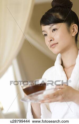 Picture - Young woman drinking tea, Saipan, Differential Focus. Fotosearch
