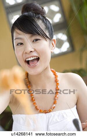 Young woman eating food, Saipan, Focus on Background View Large Photo Image Stock Image - Young woman eating food, Saipan, Focus on Background. Fotosearch