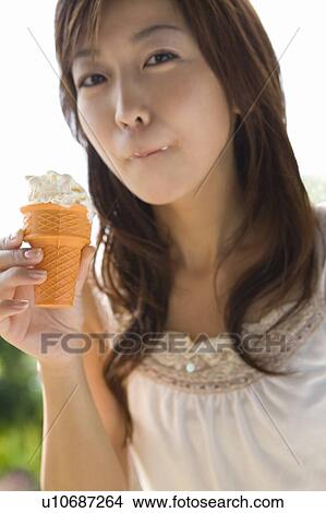 Young woman eating ice cream, Saipan View Large Photo Image Picture - Young woman eating ice cream, Saipan. Fotosearch