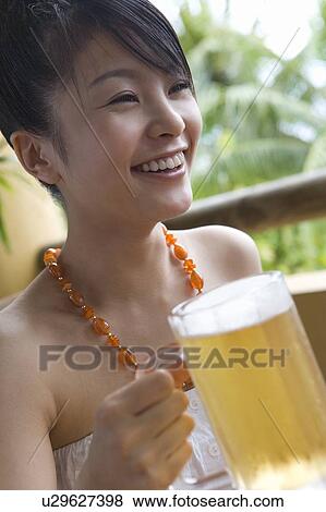 Young woman holding a beer, Saipan View Large Photo Image Stock Photo - Young woman holding a beer, Saipan. Fotosearch