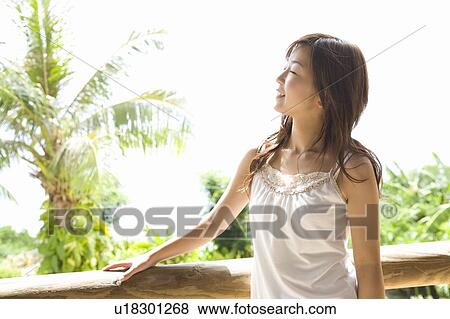 Young woman relaxing by the balcony, Saipan View Large Photo Image Stock Photo - Young woman relaxing by the balcony, Saipan. Fotosearch