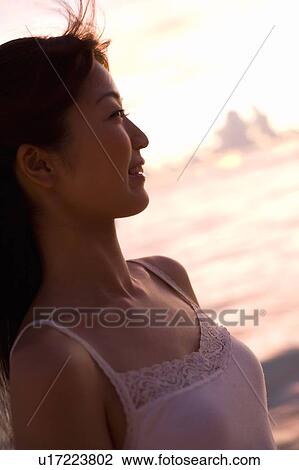 Young woman smiling on beach in the evening, differential focus, Saipan, USA View Large Photo Image Stock Image - Young woman smiling on beach in the evening, differential focus, Saipan, USA . Fotosearch
