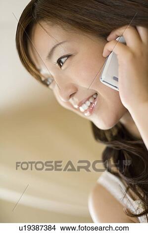 Young woman using a cell phone, Saipan View Large Photo Image Picture - Young woman using a cell phone, Saipan. Fotosearch