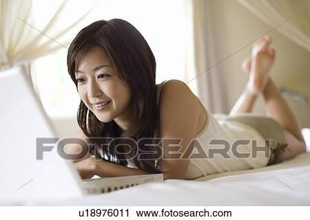 Young woman using a laptop, Saipan, Focus on Foreground View Large Photo Image Stock Image - Young woman using a laptop, Saipan, Focus on Foreground. Fotosearch