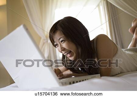 Young woman using a laptop, Saipan View Large Photo Image Stock Photograph - Young woman using a laptop, Saipan. Fotosearch