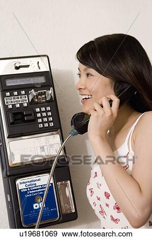 Young woman using a public phone, Saipan View Large Photo Image Stock Photo - Young woman using a public phone, Saipan. Fotosearch