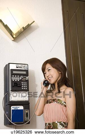 Young woman using a public phone, Saipan View Large Photo Image Stock Photograph - Young woman using a public phone, Saipan. Fotosearch