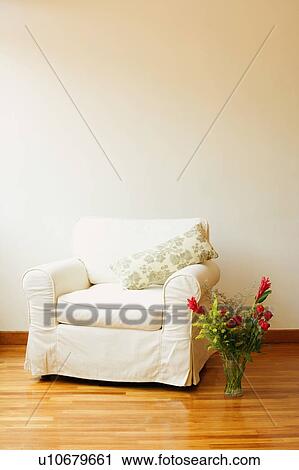Stock Image - Armchair with a flower vase. Fotosearch