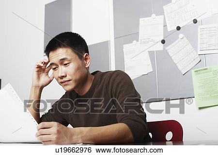 Stock Photograph - Businessman holding a printout. Fotosearch