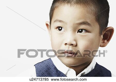 Close-up of a boy looking away View Large Photo Image Stock Photography - Close-up of a boy looking away. Fotosearch