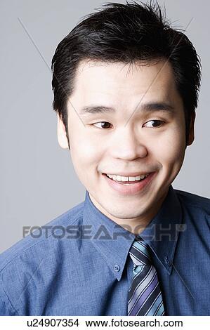 Close-up of a businessman smiling View Large Photo Image Picture - Close-up of a businessman smiling. Fotosearch