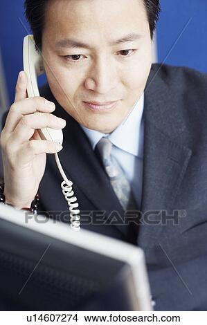 Picture - Close-up of a businessman talking on the telephone. Fotosearch