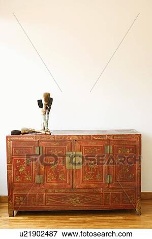 Stock Photo - Close-up of a cabinet on a wooden laminate floor. Fotosearch