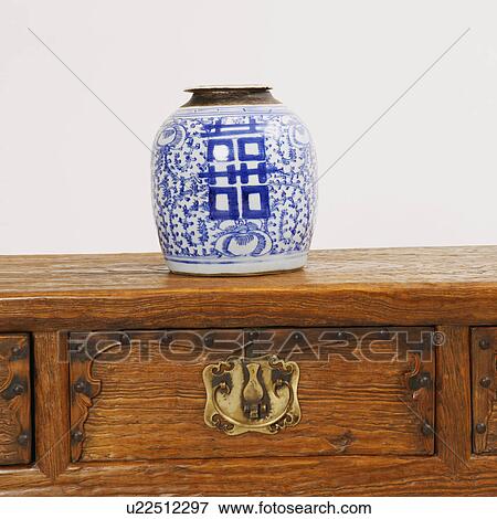 Close-up of a decorative urn on a wooden desk View Large Photo Image Stock Photo - Close-up of a decorative urn on a wooden desk. Fotosearch