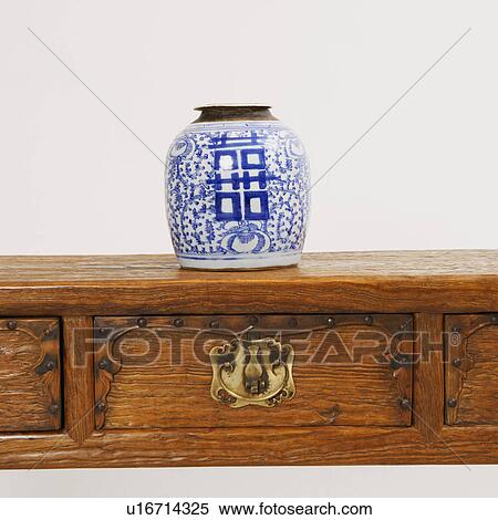 Close-up of a decorative urn on a wooden desk View Large Photo Image Stock Photography - Close-up of a decorative urn on a wooden desk. Fotosearch