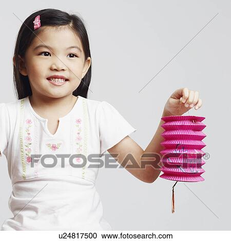 Close-up of a girl holding two Chinese lanterns and smiling View Large Photo Image Stock Image - Close-up of a girl holding two Chinese lanterns and smiling. Fotosearch