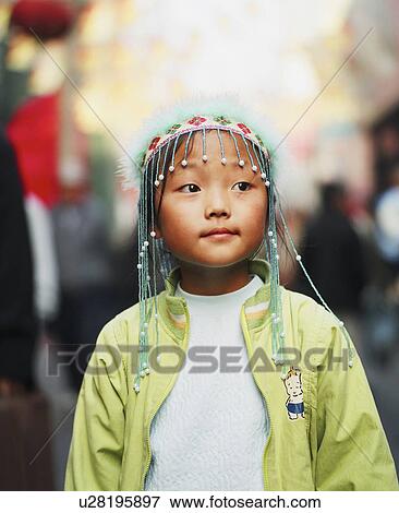 Close-up of a girl wearing an ornate headdress View Large Photo Image Stock Photo - Close-up of a girl wearing an ornate headdress. Fotosearch