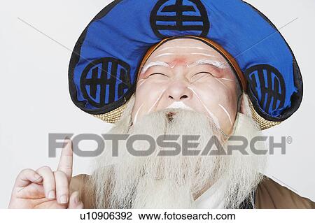 Stock Image - Close-up of a mid adult man pointing up. Fotosearch