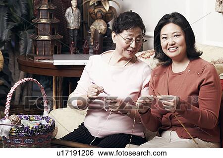 Close-up of a mother and her daughter knitting View Large Photo Image Stock Photograph - Close-up of a mother and her daughter knitting. Fotosearch