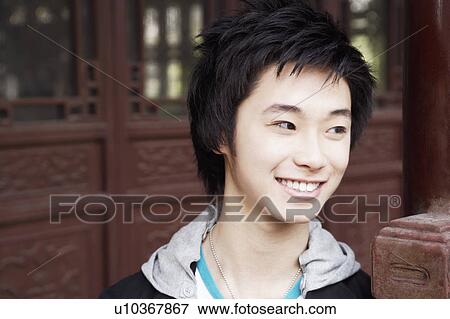 Close-up of a teenage boy looking away smiling View Large Photo Image Stock Photo - Close-up of a teenage boy looking away smiling. Fotosearch