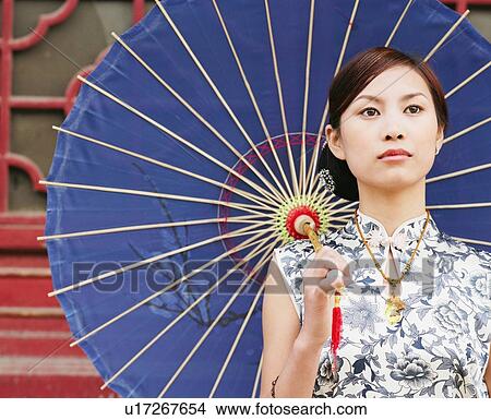 Close-up of a young woman holding a parasol View Large Photo Image Picture - Close-up of a young woman holding a parasol. Fotosearch