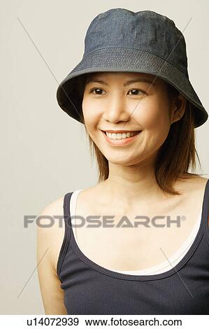 Close-up of a young woman smiling View Large Photo Image Stock Photo - Close-up of a young woman smiling. Fotosearch