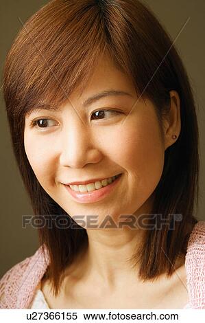 Stock Photography - Close-up of a young woman smiling. Fotosearch